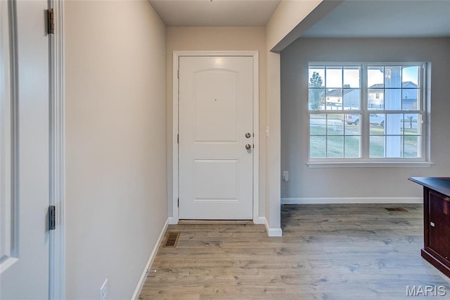entryway with light wood-type flooring and baseboards