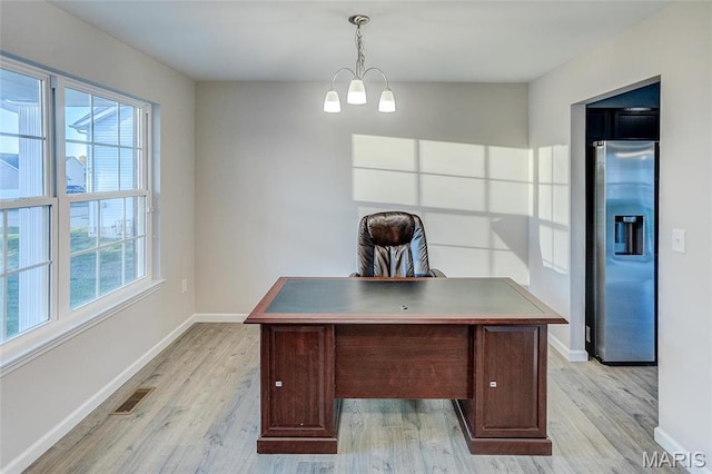 unfurnished office featuring light wood-style flooring and baseboards