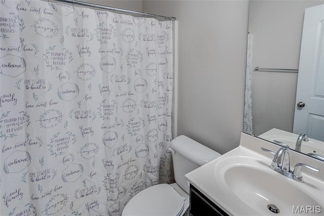 full bathroom featuring toilet, vanity, and a shower with shower curtain