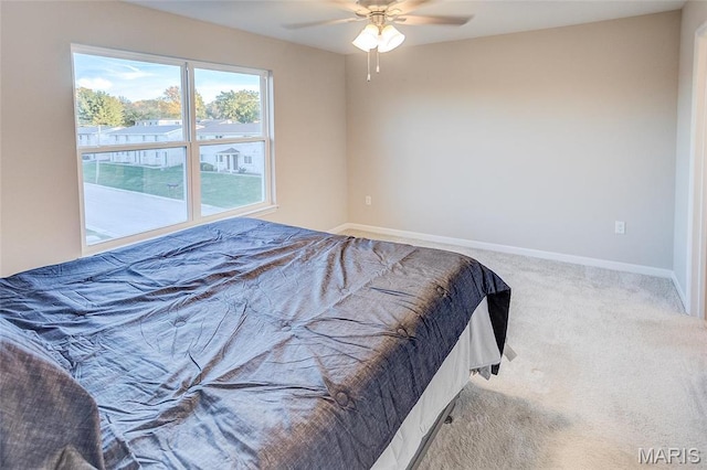 bedroom featuring carpet flooring, baseboards, and a ceiling fan