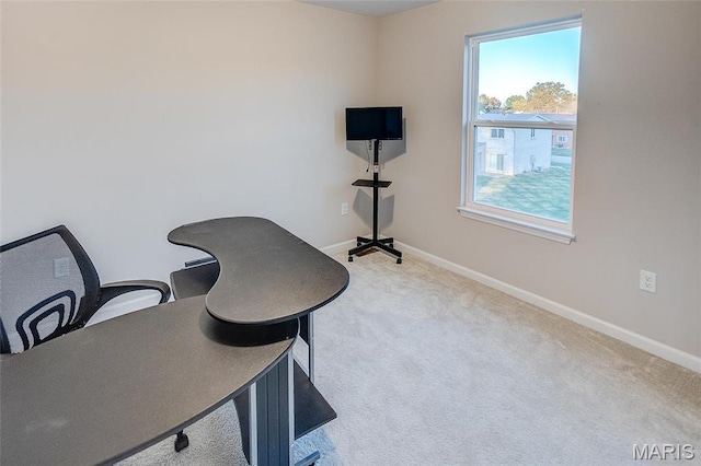 home office with plenty of natural light, carpet, and baseboards