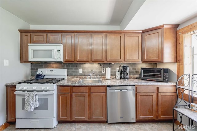 890 Tyson Dr, Florissant, MO 63031 - kitchen featuring white appliances, a sink, decorative backsplash, and brown cabinets