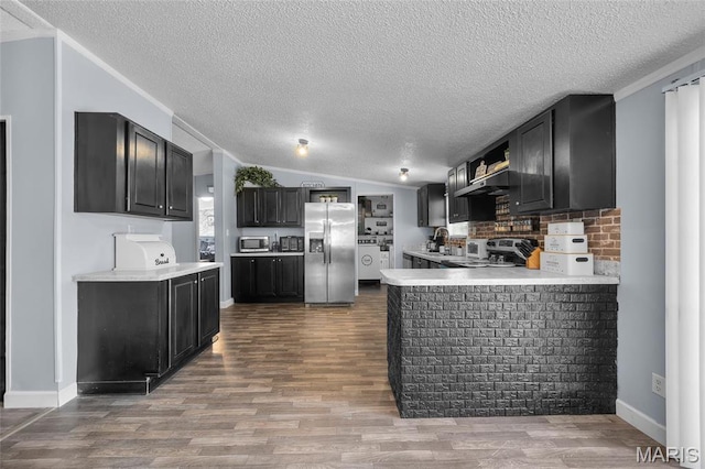29 Pine Ln, Cedar Hill, MO 63016 - kitchen featuring stainless steel appliances, dark cabinetry, a textured ceiling, light countertops, and dark wood-style floors