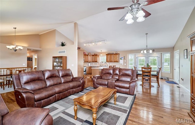 1866 Big Oak Dr, Troy, MO 63379 - living room with lofted ceiling, a chandelier, a ceiling fan, light wood-style flooring, and rail lighting