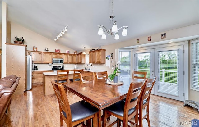 1866 Big Oak Dr, Troy, MO 63379 - dining space featuring lofted ceiling, light wood finished floors, a chandelier, and french doors