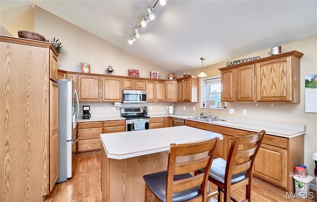 1866 Big Oak Dr, Troy, MO 63379 - kitchen with stainless steel appliances, a sink, vaulted ceiling, a center island, and light countertops