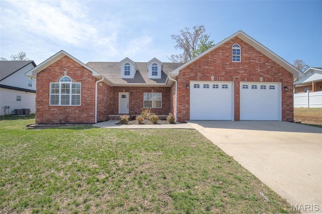 2940 Karmen Ln, Poplar Bluff, MO 63901 - view of front facade featuring driveway, an attached garage, a front yard, brick siding, and cooling unit