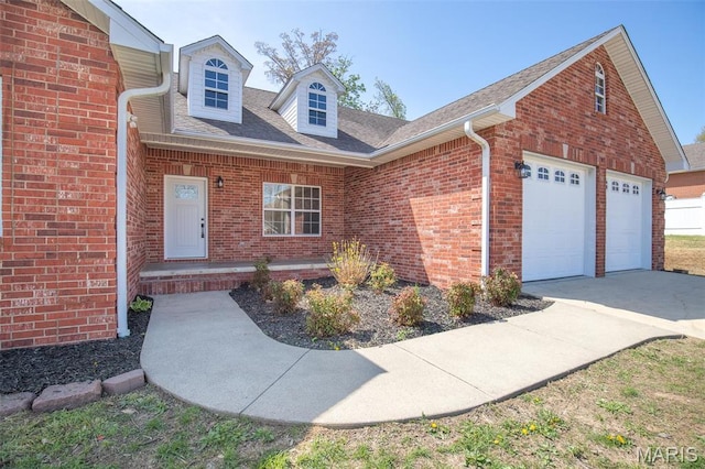2940 Karmen Ln, Poplar Bluff, MO 63901 - view of front of house featuring brick siding, concrete driveway, a garage, and roof with shingles