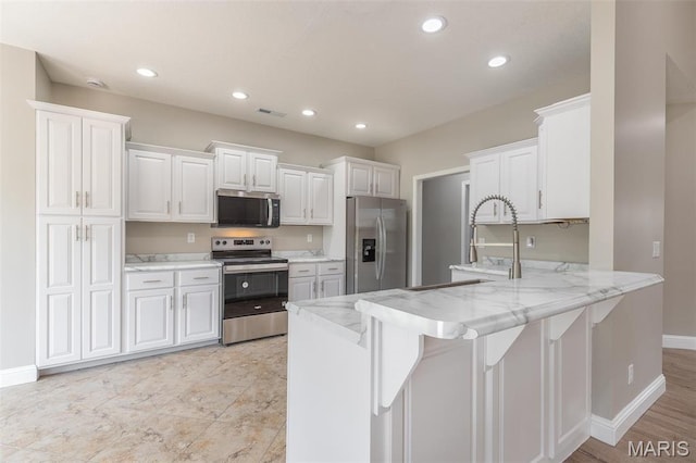 2940 Karmen Ln, Poplar Bluff, MO 63901 - kitchen featuring stainless steel appliances, a peninsula, baseboards, white cabinets, and recessed lighting