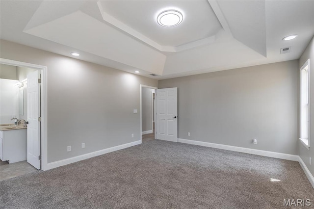 2940 Karmen Ln, Poplar Bluff, MO 63901 - unfurnished bedroom featuring a tray ceiling, light carpet, a sink, recessed lighting, and baseboards