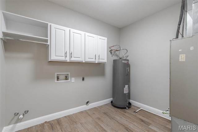 2940 Karmen Ln, Poplar Bluff, MO 63901 - laundry area featuring hookup for an electric dryer, electric water heater, washer hookup, light wood-style flooring, and cabinet space