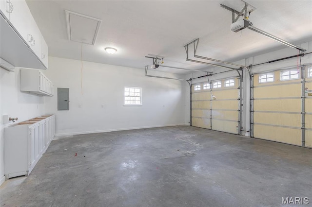 2940 Karmen Ln, Poplar Bluff, MO 63901 - garage featuring a garage door opener, electric panel, and baseboards
