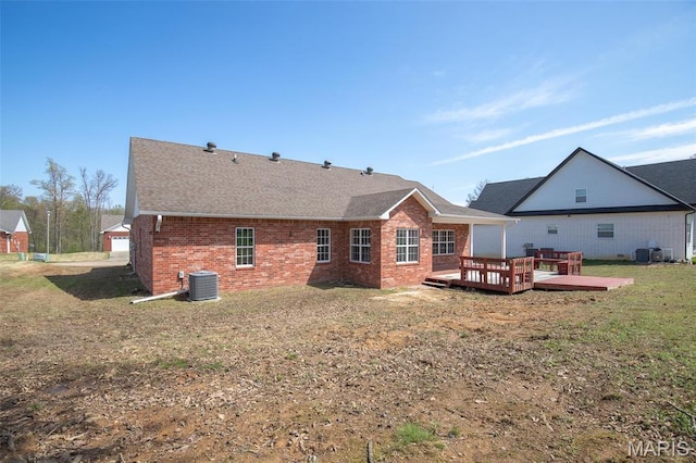 2940 Karmen Ln, Poplar Bluff, MO 63901 - rear view of property featuring brick siding, a deck, a lawn, roof with shingles, and central AC