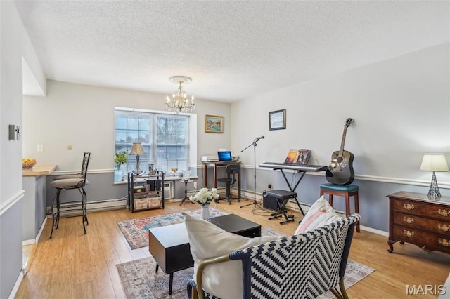 living room featuring a textured ceiling, wood finished floors, a chandelier, a desk, and baseboard heating