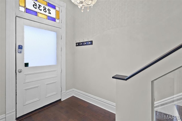 2835 Shenandoah Ave, Saint Louis, MO 63104 - doorway with dark wood-type flooring, baseboards, and a chandelier