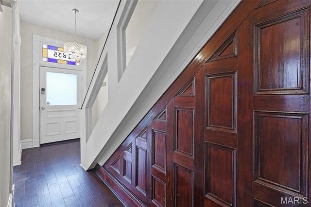 2835 Shenandoah Ave, Saint Louis, MO 63104 - corridor with a chandelier, baseboards, and dark wood-style flooring