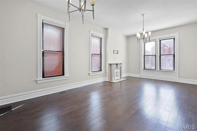 2835 Shenandoah Ave, Saint Louis, MO 63104 - unfurnished dining area featuring a chandelier, dark wood-style floors, and baseboards