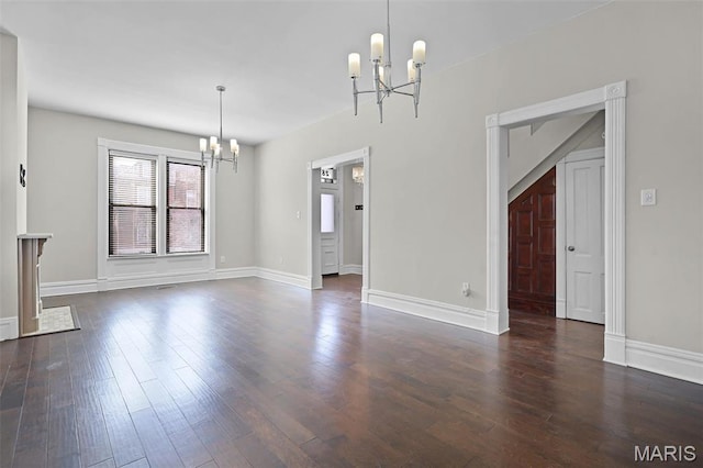 2835 Shenandoah Ave, Saint Louis, MO 63104 - unfurnished dining area featuring a chandelier, dark wood finished floors, and baseboards