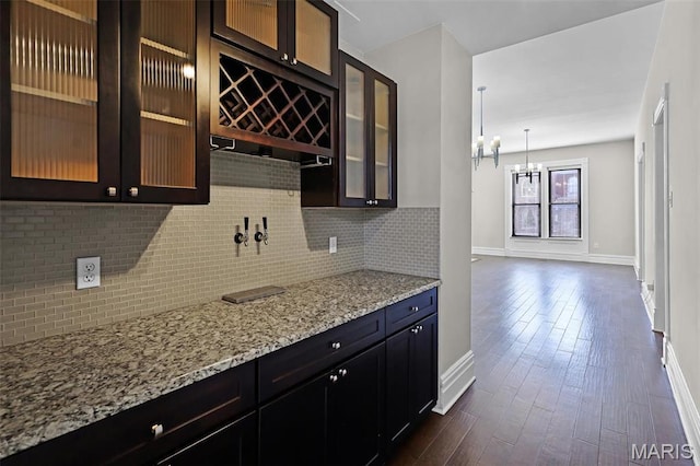2835 Shenandoah Ave, Saint Louis, MO 63104 - kitchen with baseboards, a chandelier, backsplash, and light stone countertops