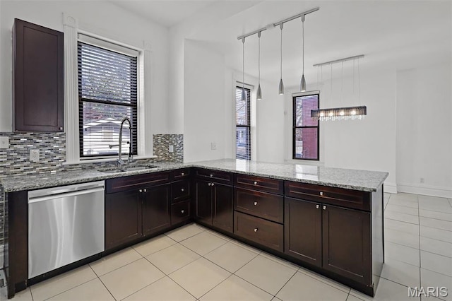 2835 Shenandoah Ave, Saint Louis, MO 63104 - kitchen with stainless steel dishwasher, a sink, light stone countertops, and light tile patterned floors