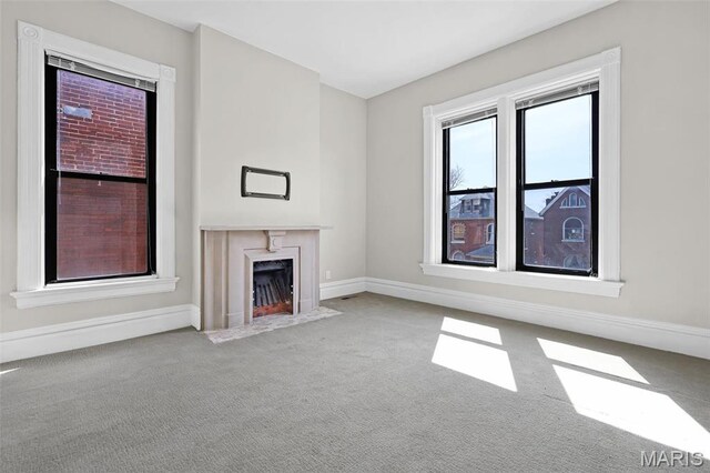 2835 Shenandoah Ave, Saint Louis, MO 63104 - unfurnished living room with carpet flooring, baseboards, and a premium fireplace