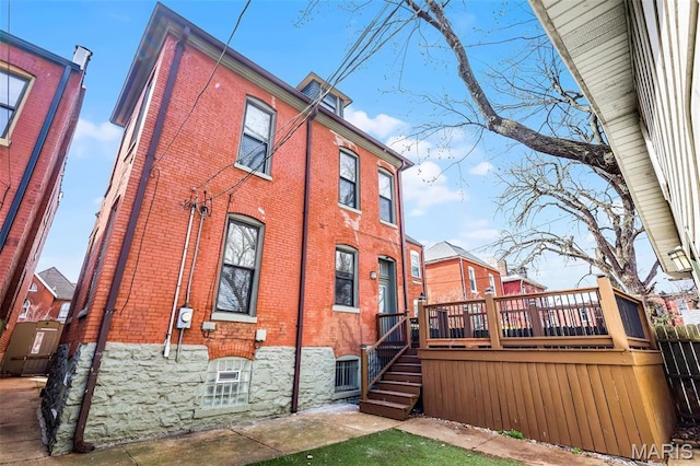 2835 Shenandoah Ave, Saint Louis, MO 63104 - rear view of house featuring brick siding, a deck, stairs, and fence