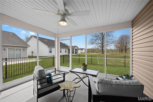 sunroom / solarium featuring ceiling fan