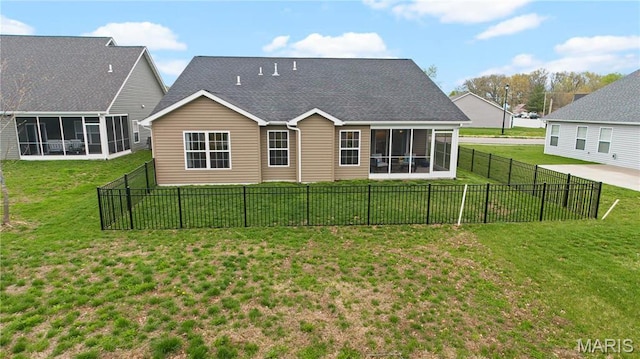 back of house with a sunroom and roof with shingles
