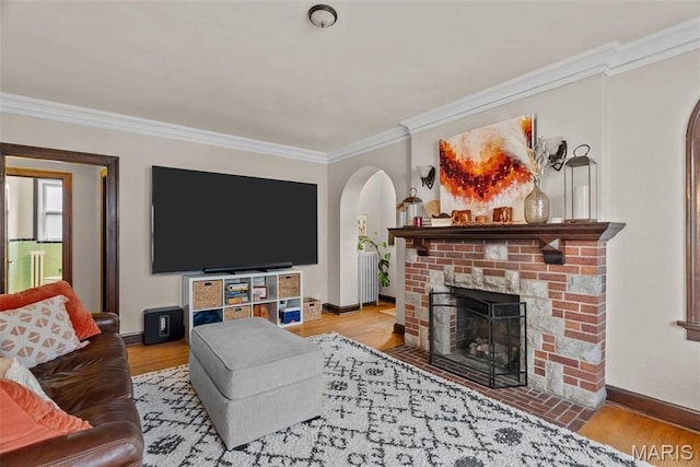 3981 Canterbury Dr, Saint Louis, MO 63121 - living area with crown molding, arched walkways, baseboards, a fireplace, and wood finished floors