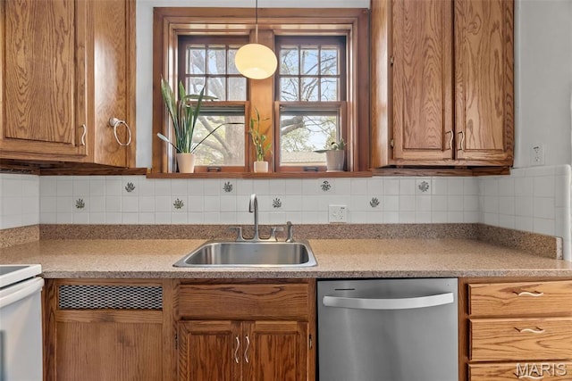 3981 Canterbury Dr, Saint Louis, MO 63121 - kitchen featuring stainless steel dishwasher, a sink, brown cabinetry, and decorative backsplash