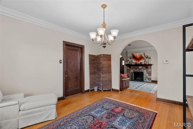 3981 Canterbury Dr, Saint Louis, MO 63121 - dining room featuring arched walkways, a chandelier, crown molding, baseboards, and wood finished floors