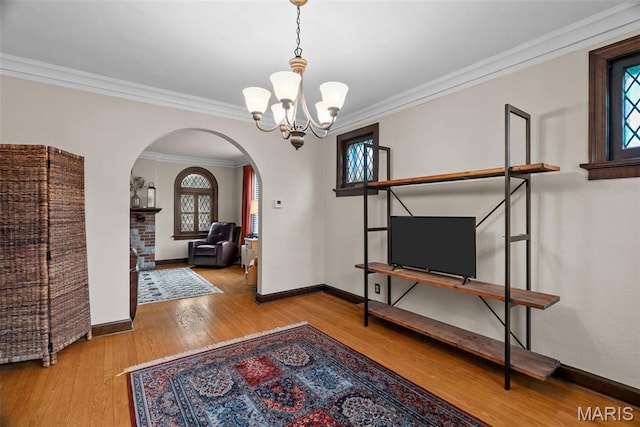 3981 Canterbury Dr, Saint Louis, MO 63121 - dining room with arched walkways, a chandelier, wood finished floors, baseboards, and ornamental molding