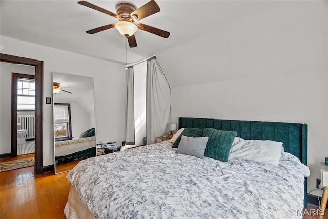 3981 Canterbury Dr, Saint Louis, MO 63121 - bedroom with lofted ceiling, wood finished floors, radiator, and a ceiling fan