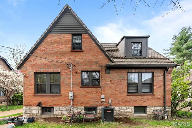 3981 Canterbury Dr, Saint Louis, MO 63121 - back of property featuring central AC unit and brick siding