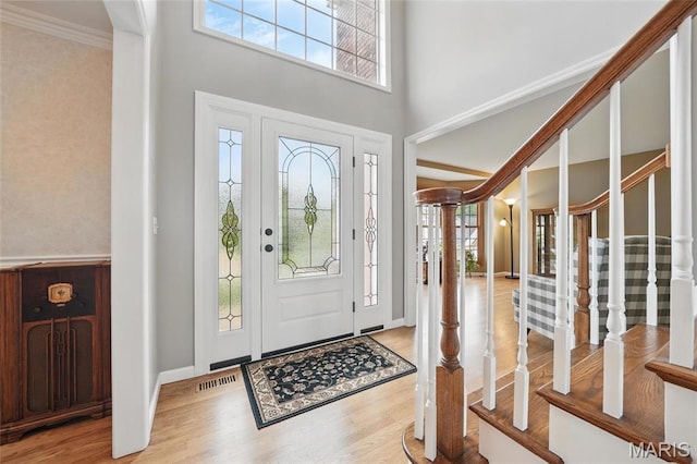 13456 Sunset Meadows Ln, Saint Louis, MO 63128 - entrance foyer featuring wood finished floors, a high ceiling, crown molding, stairway, and baseboards