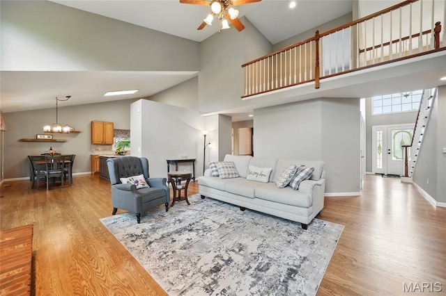 13456 Sunset Meadows Ln, Saint Louis, MO 63128 - living area with light wood-style flooring, high vaulted ceiling, a ceiling fan, baseboards, and a chandelier