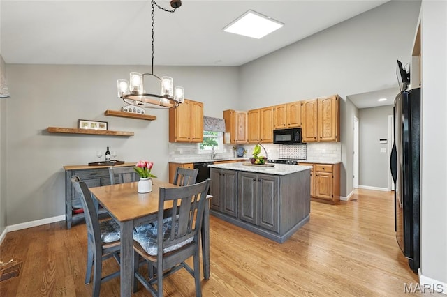 13456 Sunset Meadows Ln, Saint Louis, MO 63128 - kitchen featuring black appliances, backsplash, light countertops, a chandelier, and high vaulted ceiling