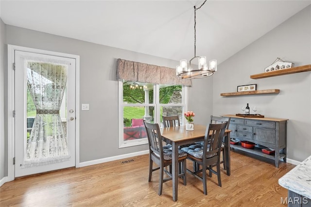 13456 Sunset Meadows Ln, Saint Louis, MO 63128 - dining area featuring a chandelier, plenty of natural light, light wood-style flooring, and vaulted ceiling