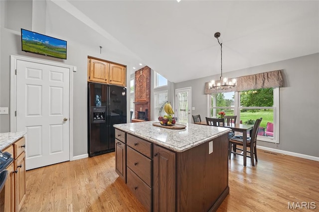 13456 Sunset Meadows Ln, Saint Louis, MO 63128 - kitchen featuring black fridge with ice dispenser, vaulted ceiling, a chandelier, plenty of natural light, and light wood finished floors