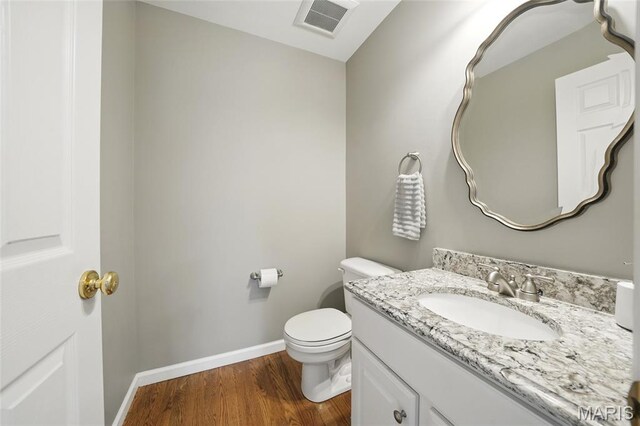 13456 Sunset Meadows Ln, Saint Louis, MO 63128 - bathroom featuring wood finished floors, baseboards, toilet, and vanity