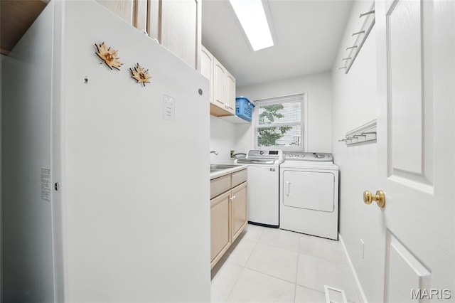 13456 Sunset Meadows Ln, Saint Louis, MO 63128 - clothes washing area with washing machine and clothes dryer, cabinet space, and light tile patterned floors
