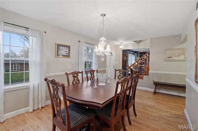 827 Yosemite Dr, Saint Louis, MO 63122 - dining space featuring a chandelier, light wood-style floors, stairway, and baseboards