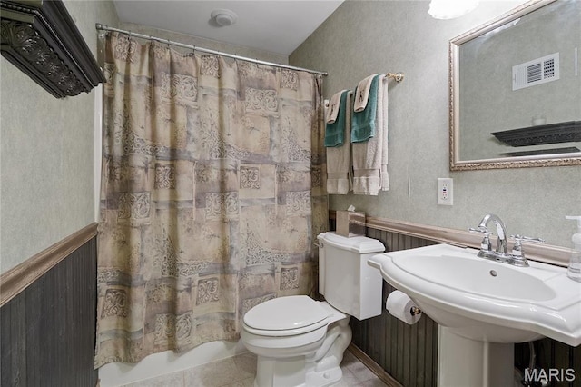 827 Yosemite Dr, Saint Louis, MO 63122 - bathroom with toilet, wainscoting, a sink, and tile patterned flooring