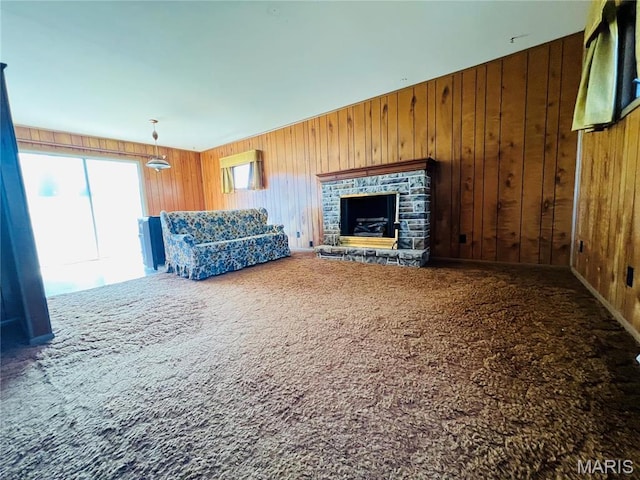 604 Salling St, Perry, MO 63462 - unfurnished living room featuring carpet, wood walls, and a fireplace with raised hearth