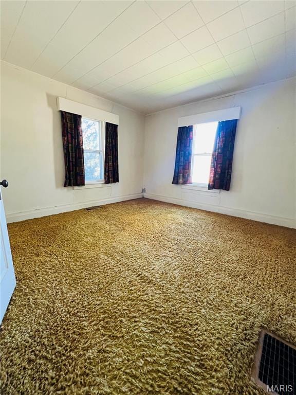 604 Salling St, Perry, MO 63462 - spare room featuring plenty of natural light, baseboards, and speckled floor