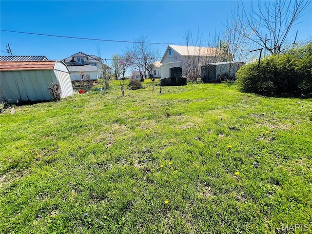 604 Salling St, Perry, MO 63462 - view of grassy yard with an outdoor structure and a storage unit