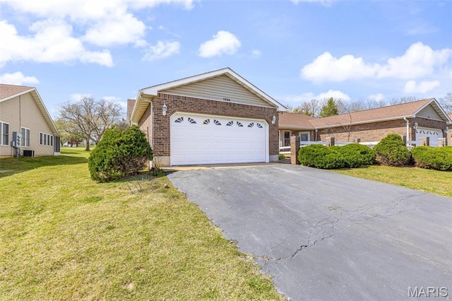 1654 Napoleon Dr, Bonne Terre, MO 63628 - view of front of house featuring brick siding, asphalt driveway, a garage, and a front lawn