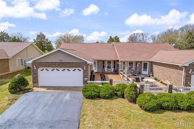 1654 Napoleon Dr, Bonne Terre, MO 63628 - ranch-style home featuring brick siding, driveway, an attached garage, and a front lawn