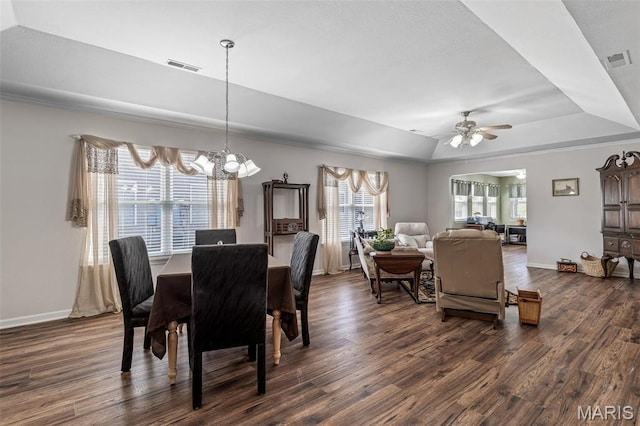1654 Napoleon Dr, Bonne Terre, MO 63628 - dining area featuring a tray ceiling, a chandelier, dark wood-type flooring, a ceiling fan, and baseboards