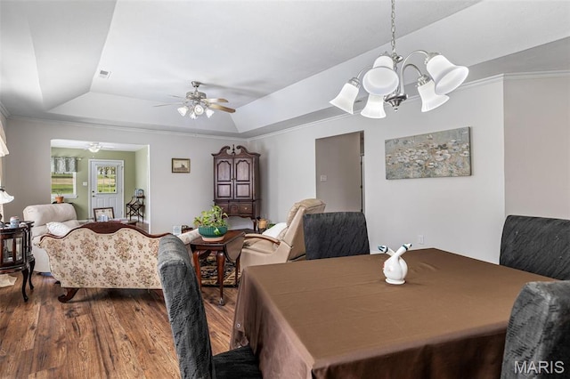1654 Napoleon Dr, Bonne Terre, MO 63628 - dining space featuring a raised ceiling, ceiling fan, a chandelier, dark wood-style floors, and ornamental molding
